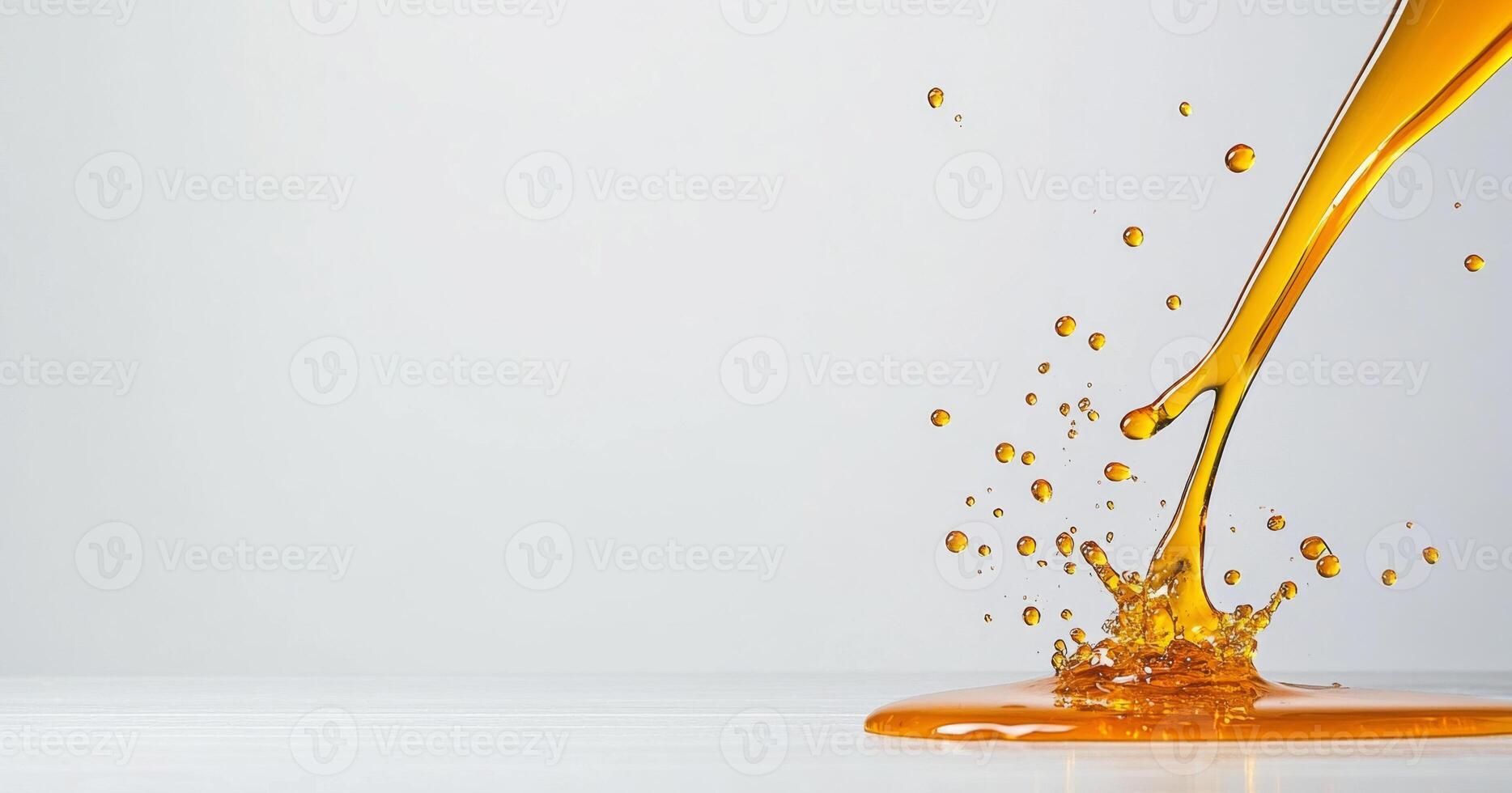 Golden honey flows gracefully, creating splashes as it meets a smooth surface. This moment captures the rich texture and vibrant color, showcasing the natural beauty of honey in action. photo