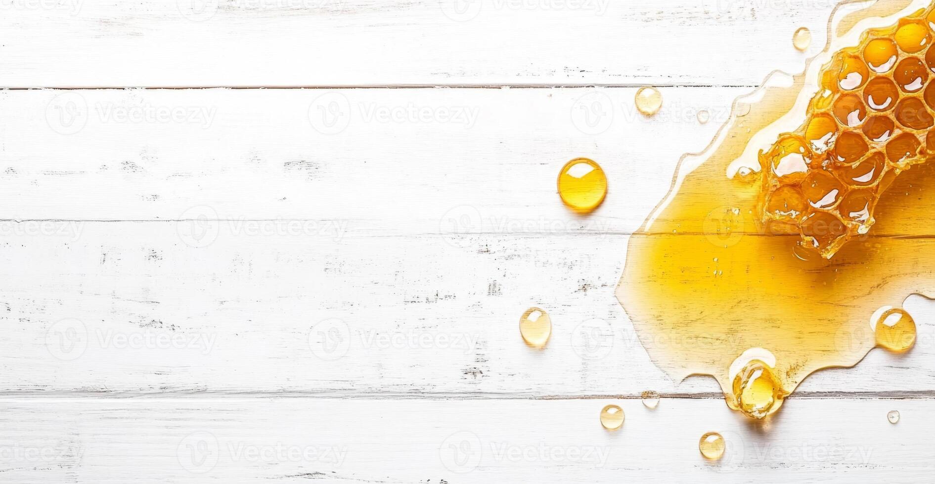 Honey drizzles and splashes on a rustic white wooden surface, showcasing its rich golden color. The liquid forms droplets around a honeycomb, creating a visually appealing arrangement. photo