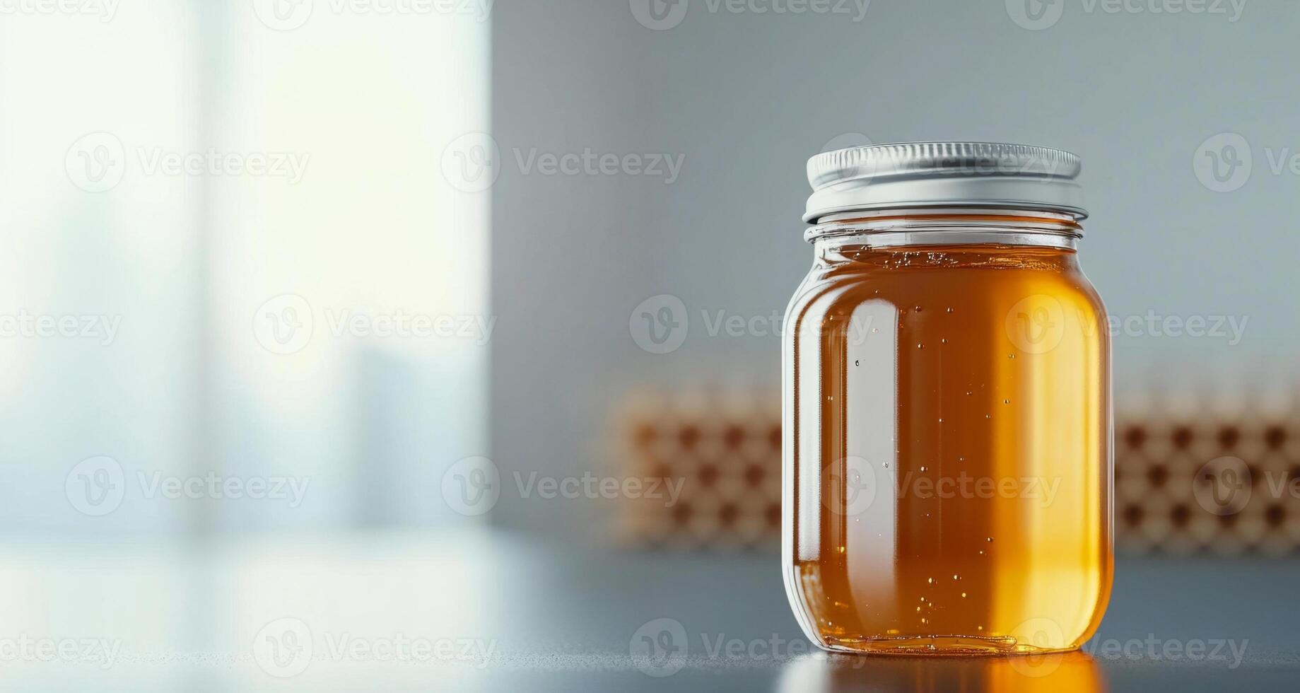Fresh organic honey is displayed in a glass jar in a bright kitchen. The natural sweetness and rich golden color highlight the importance of sustainable beekeeping practices. photo