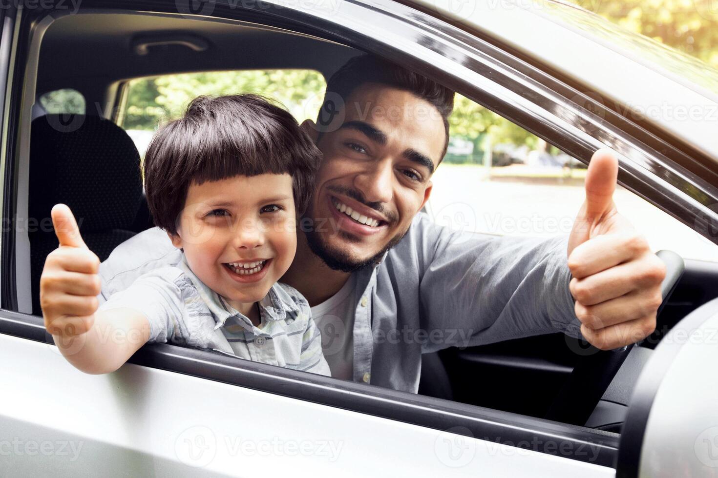 Happy Arab Father And His Little Son Sitting In Car And Showing Thumbs Up At Camera Through Open Window, Cheerful Middle Eastern Family Dad And Child Recommending Car Rental Service, Closeup photo