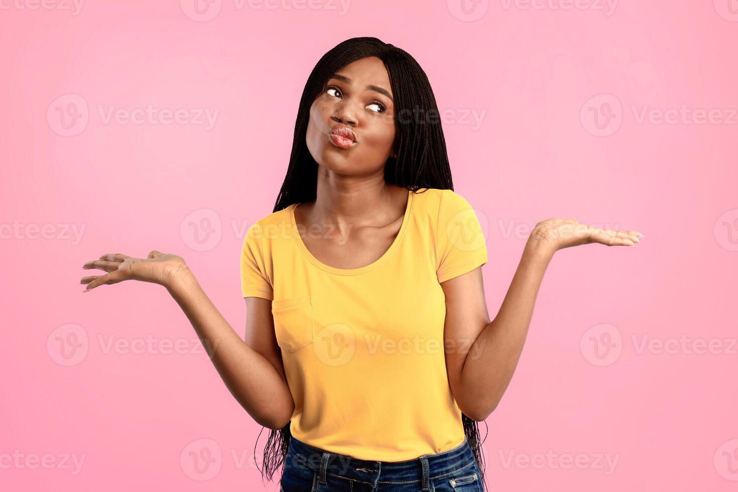 Choice And Comparison Concept. Thoughtful African American Woman Holding Two Invisible Objects Thinking Which One To Choose Standing Over Blue Background. Studio Shot photo