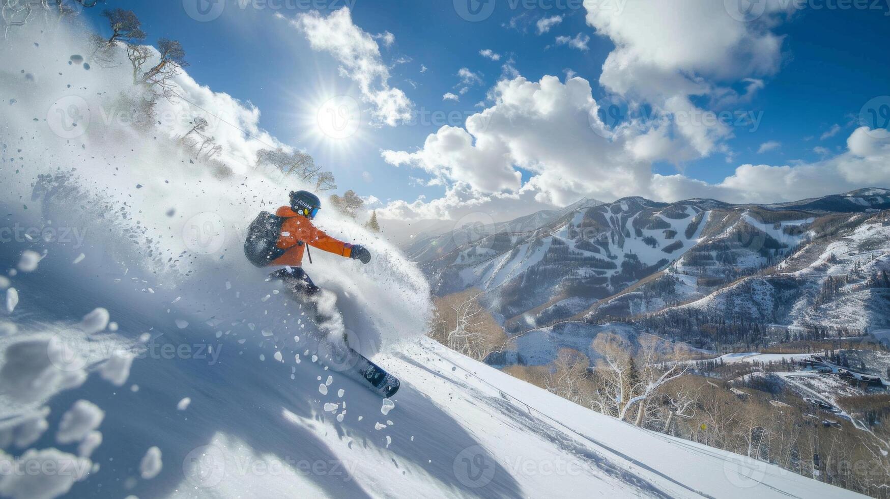 A skier expertly maneuvers through fresh powder, sending snow flying against a backdrop of majestic mountains and a bright blue sky. Sunlight enhances the winter sports atmosphere. photo