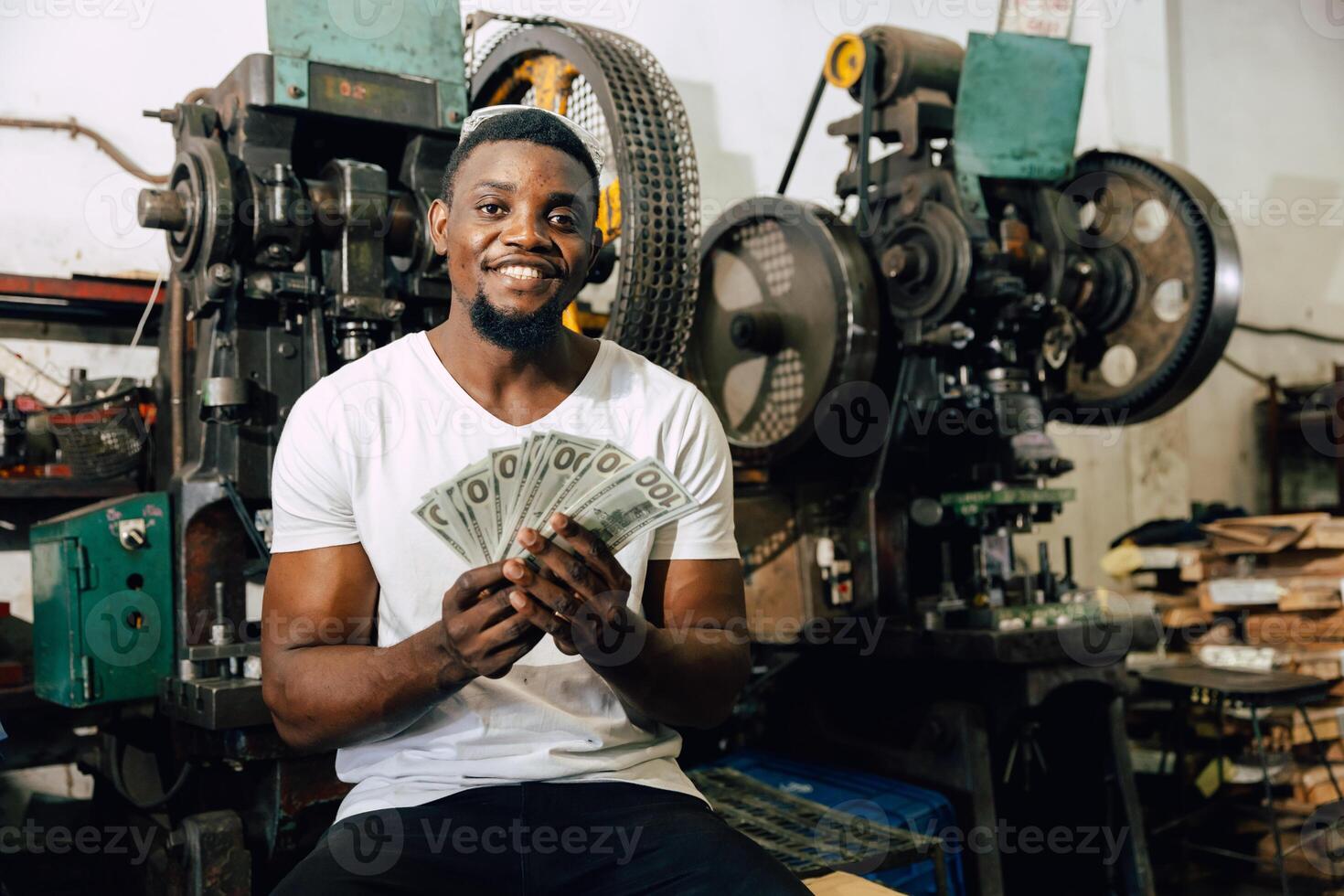 black labor worker get paid salary man enjoy with payroll money income from hard work in factory photo