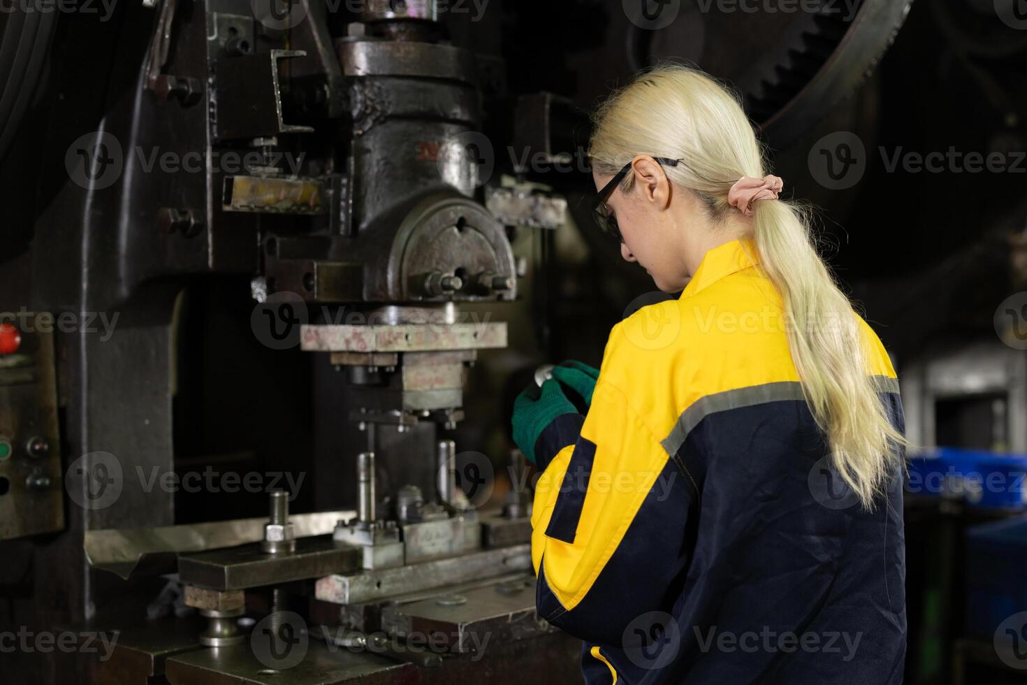 women worker working in metal industry factory punching stamping steel machine photo