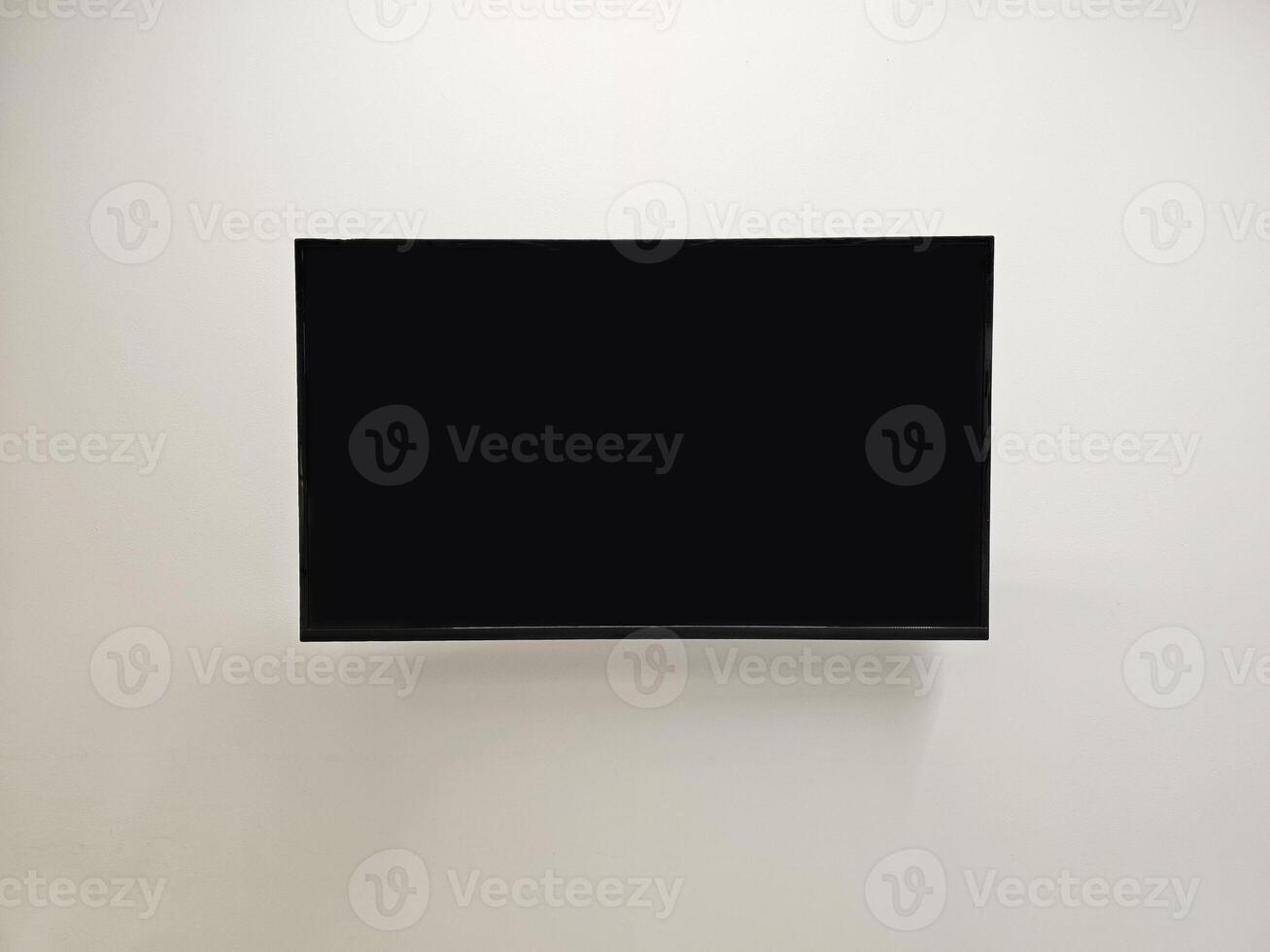 Blank Television Monitor on White Concrete Wall, Suitable for Advertising. photo