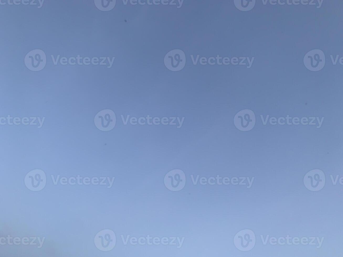 A view of a bright blue sky with white clouds photo