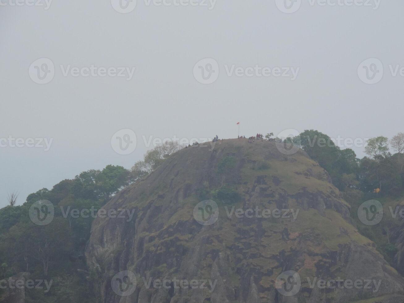 a mountain with a large rock on top photo