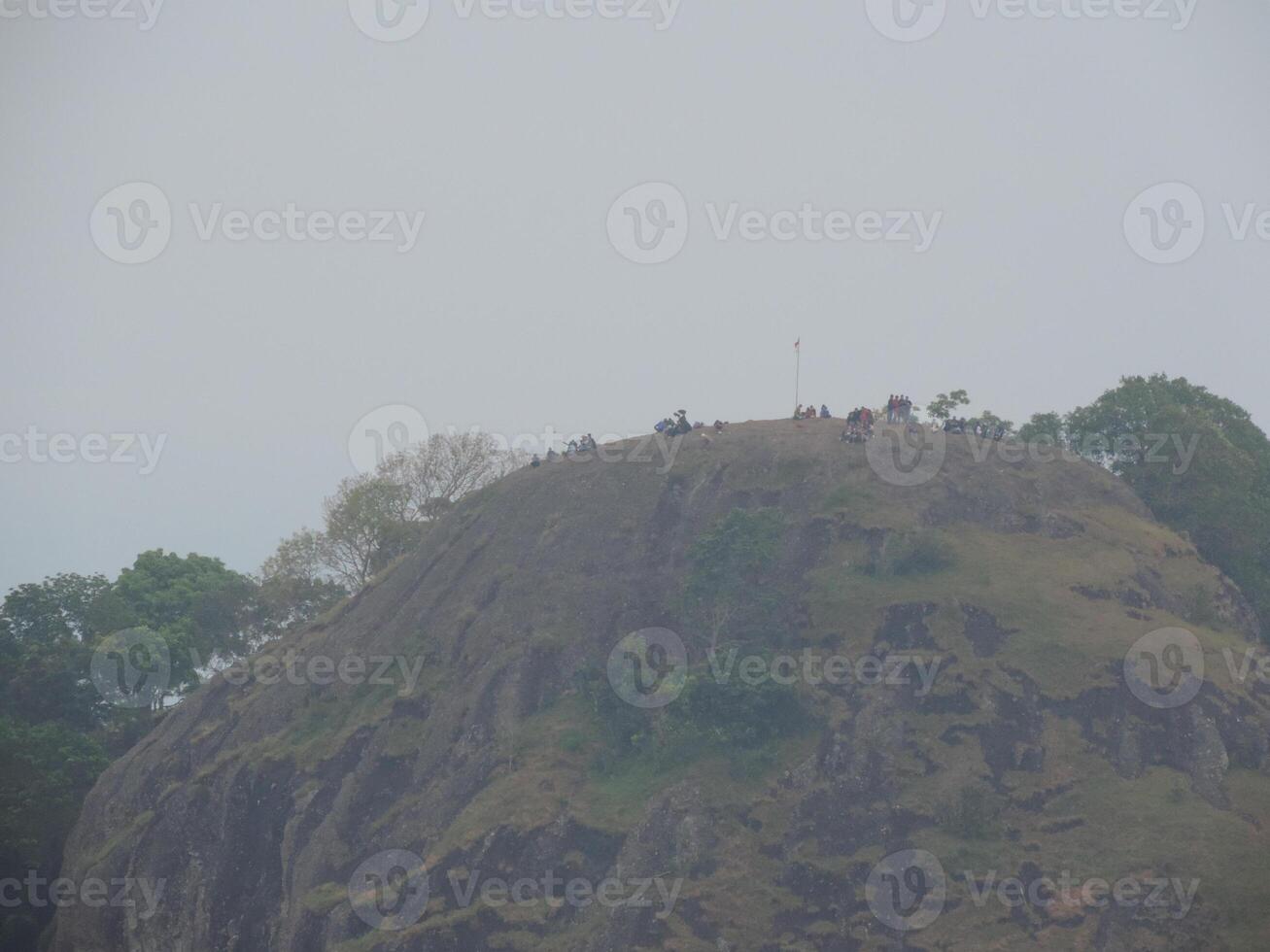 a group of people on top of a mountain photo