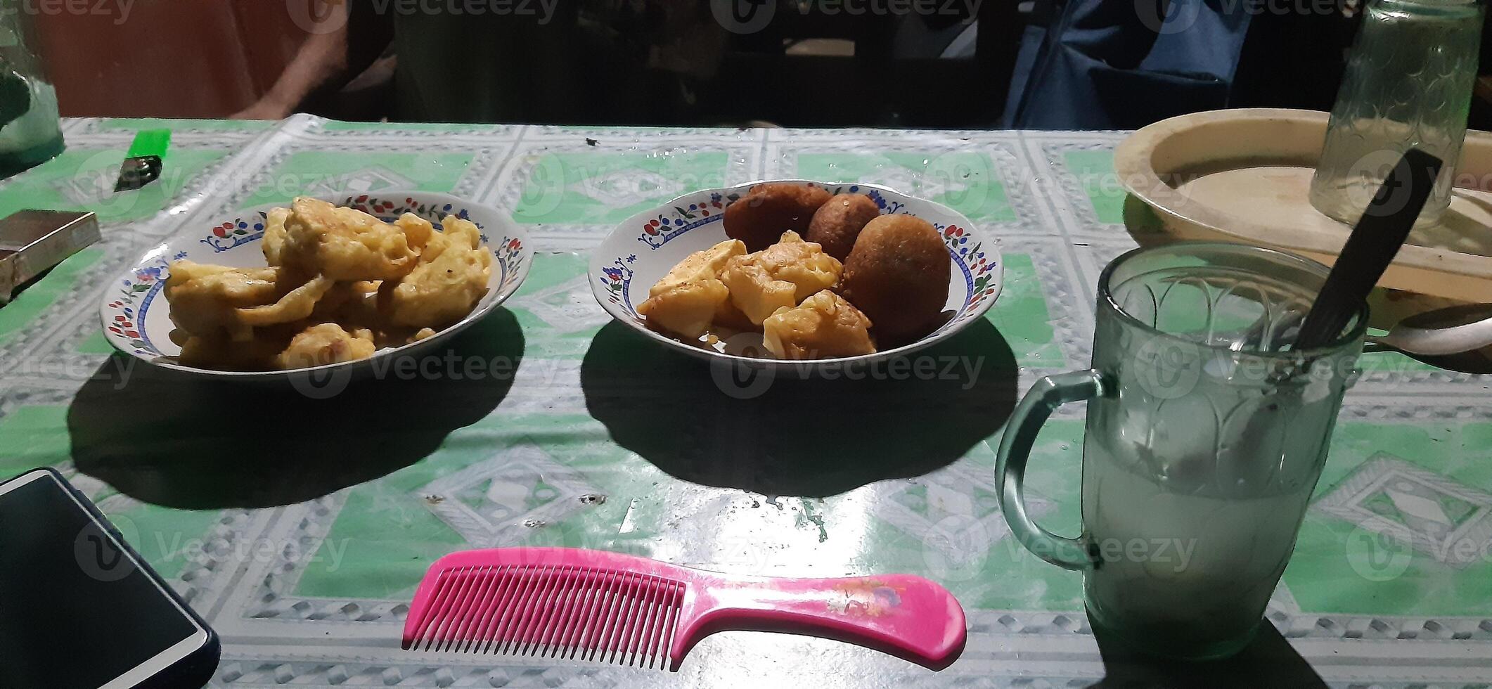 two bowls of food on a table with a drink and a comb photo