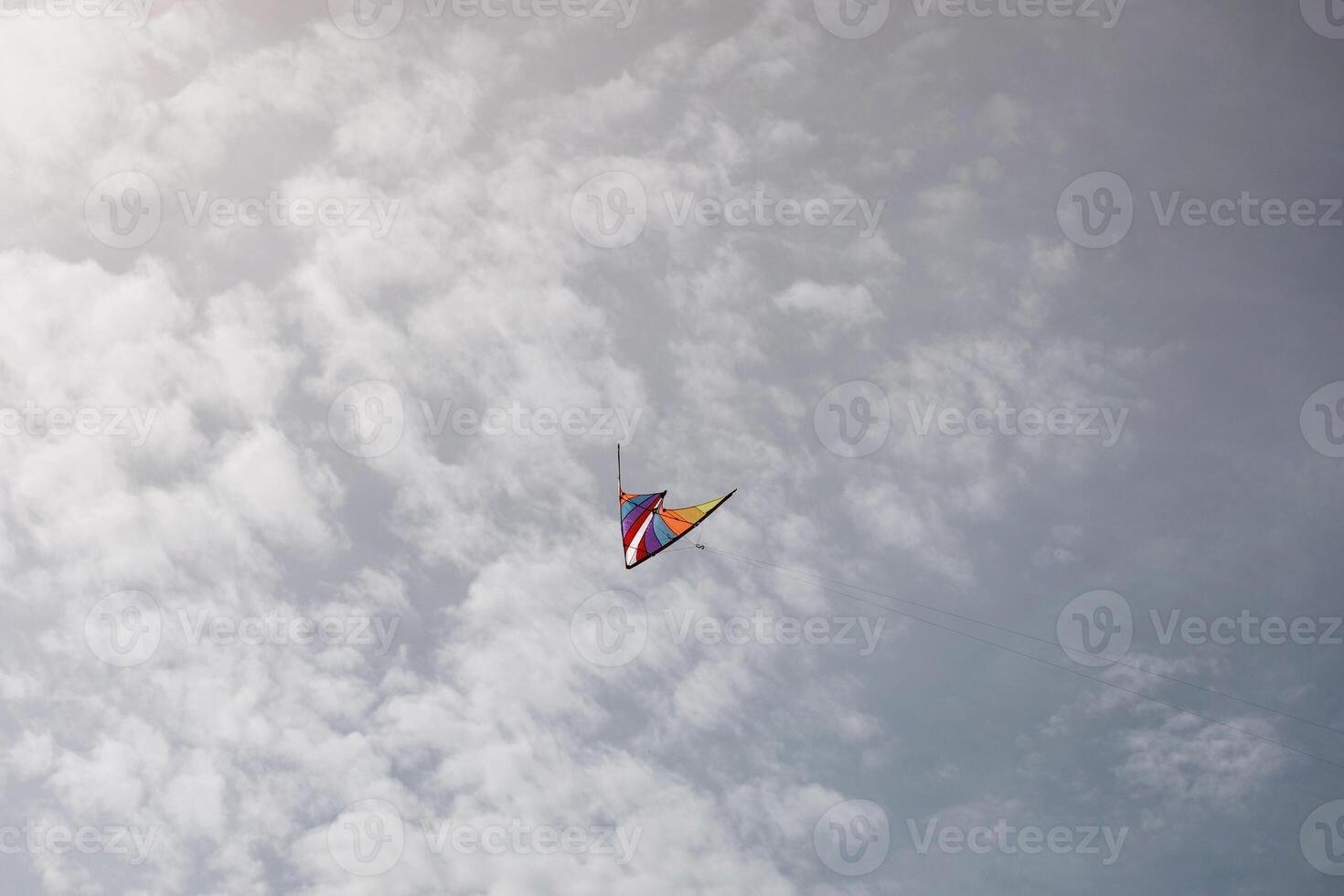 colorful kite flying with waving in sky photo