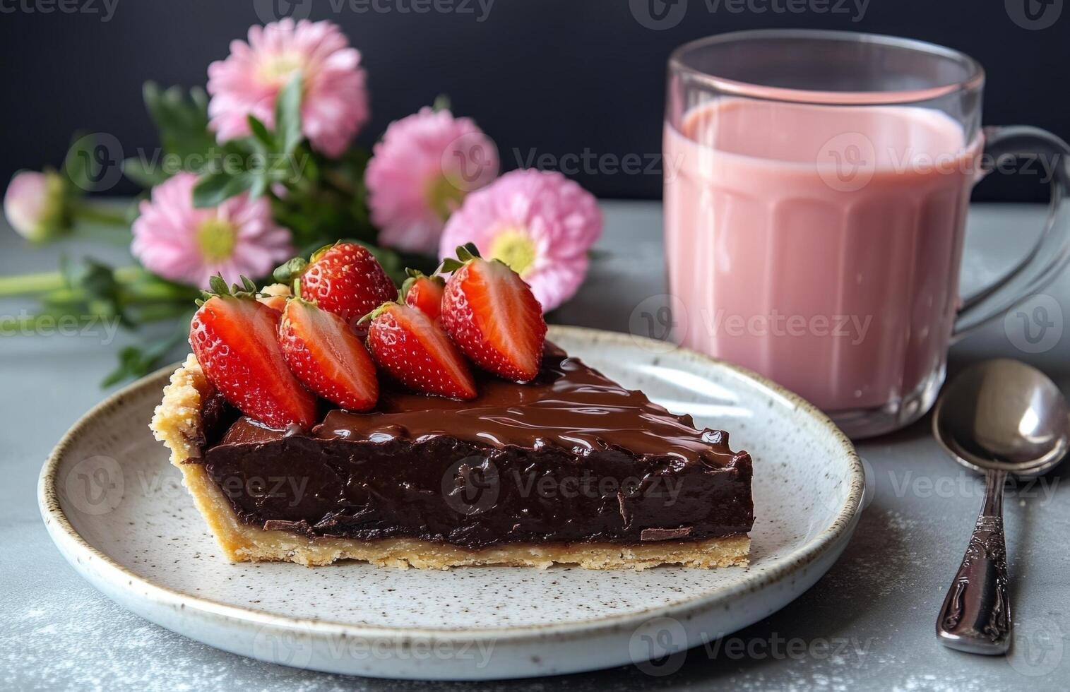 Chocolate tart slice with strawberries, pink milk, and flowers on table photo