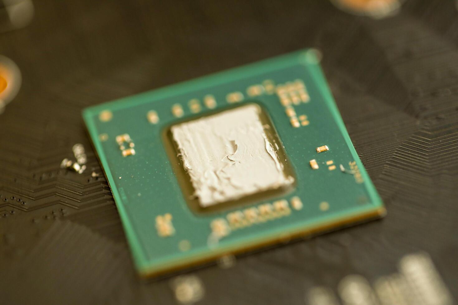 KYIV, UKRAINE - JANUARY 29, 2025 applying thermal paste on a processor for better cooling, computer maintenance, GPU installation, thermal paste application photo