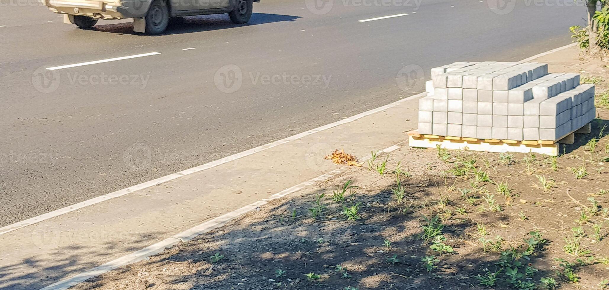 A truck driving down the road with a stack of bricks photo
