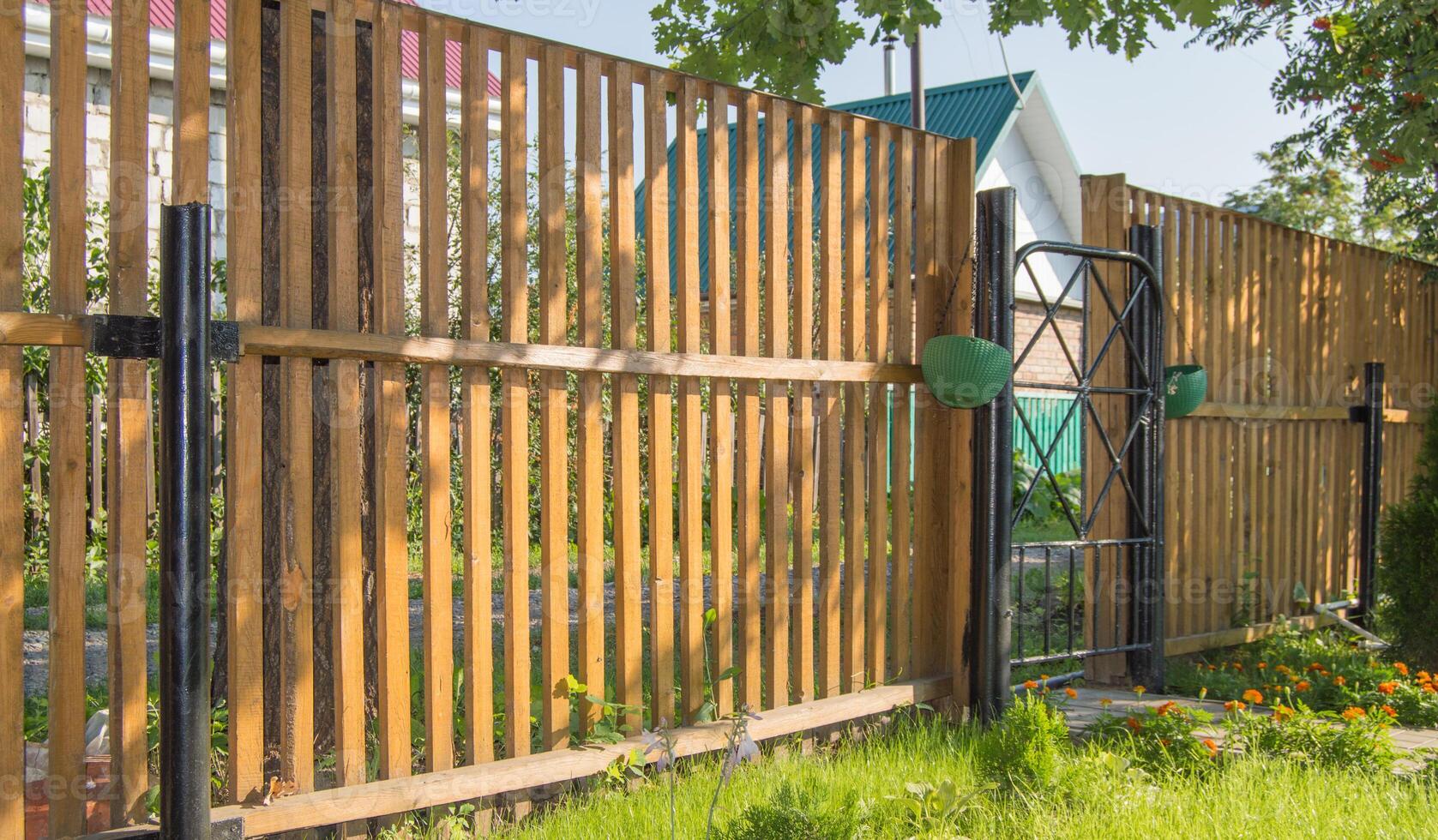 A wooden fence with a gate and a gate photo