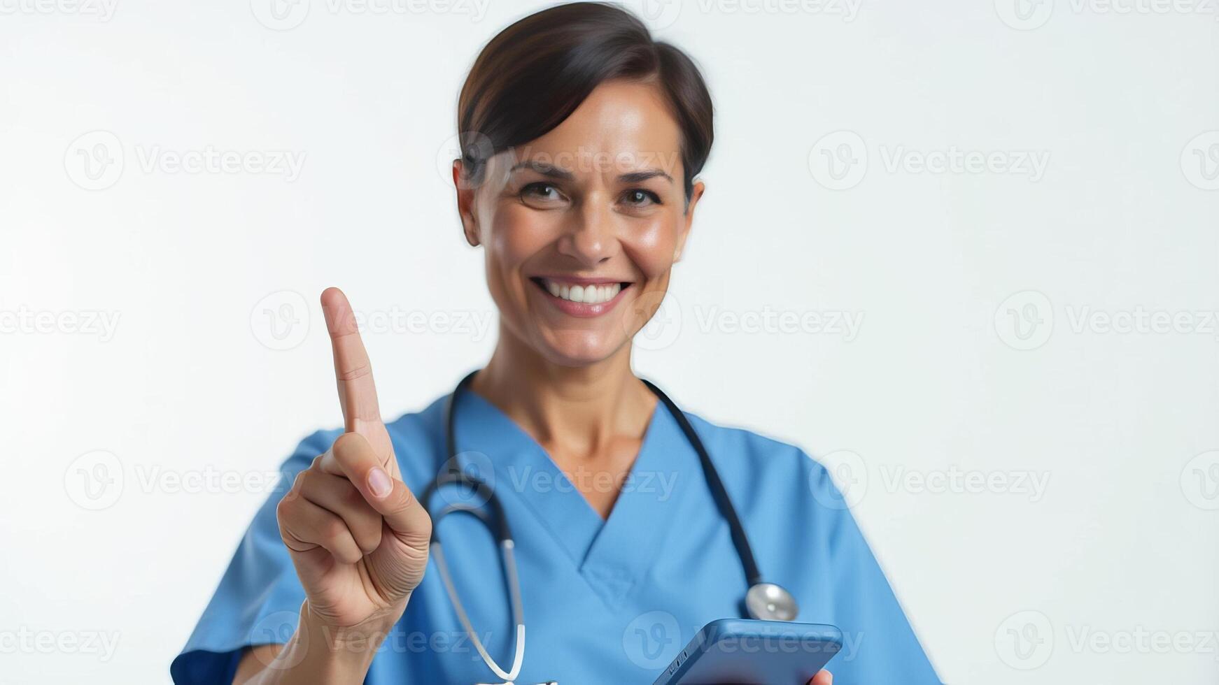 A woman in a blue scrub suit holding a cell phone photo
