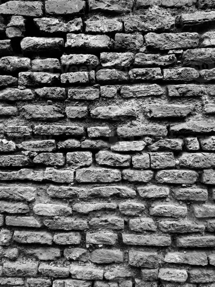 Potrait Black and White Brick Wall with Dark Stone Texture and Overhead Lighting Effect photo