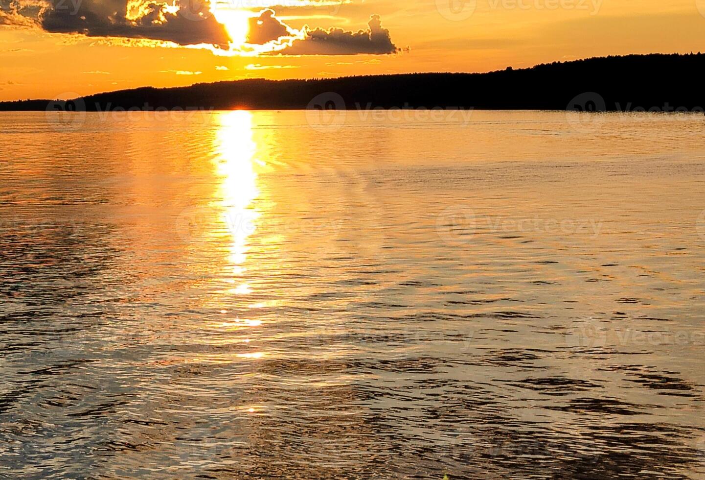 A person is standing on a surf board in the water photo