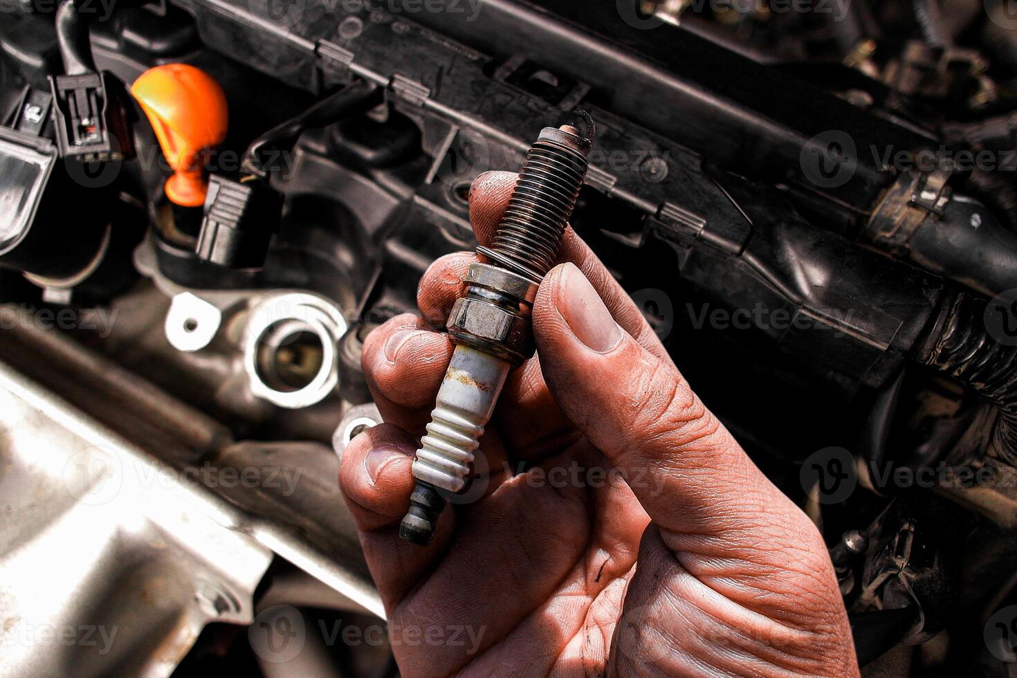Close up of car spark plug in mechanic hand , Car maintenance concept photo