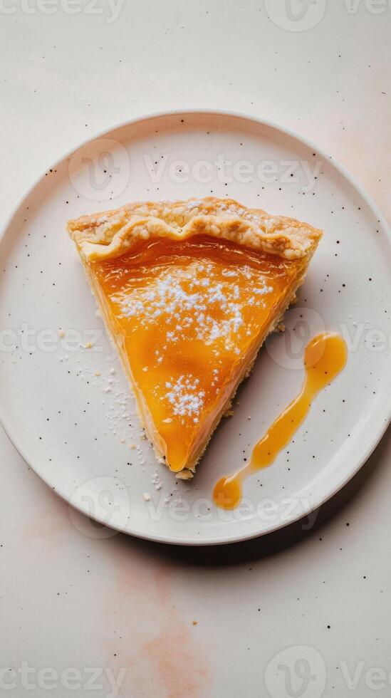 Slice of pie with layers of golden peach jam and creamy vanilla filling. photo