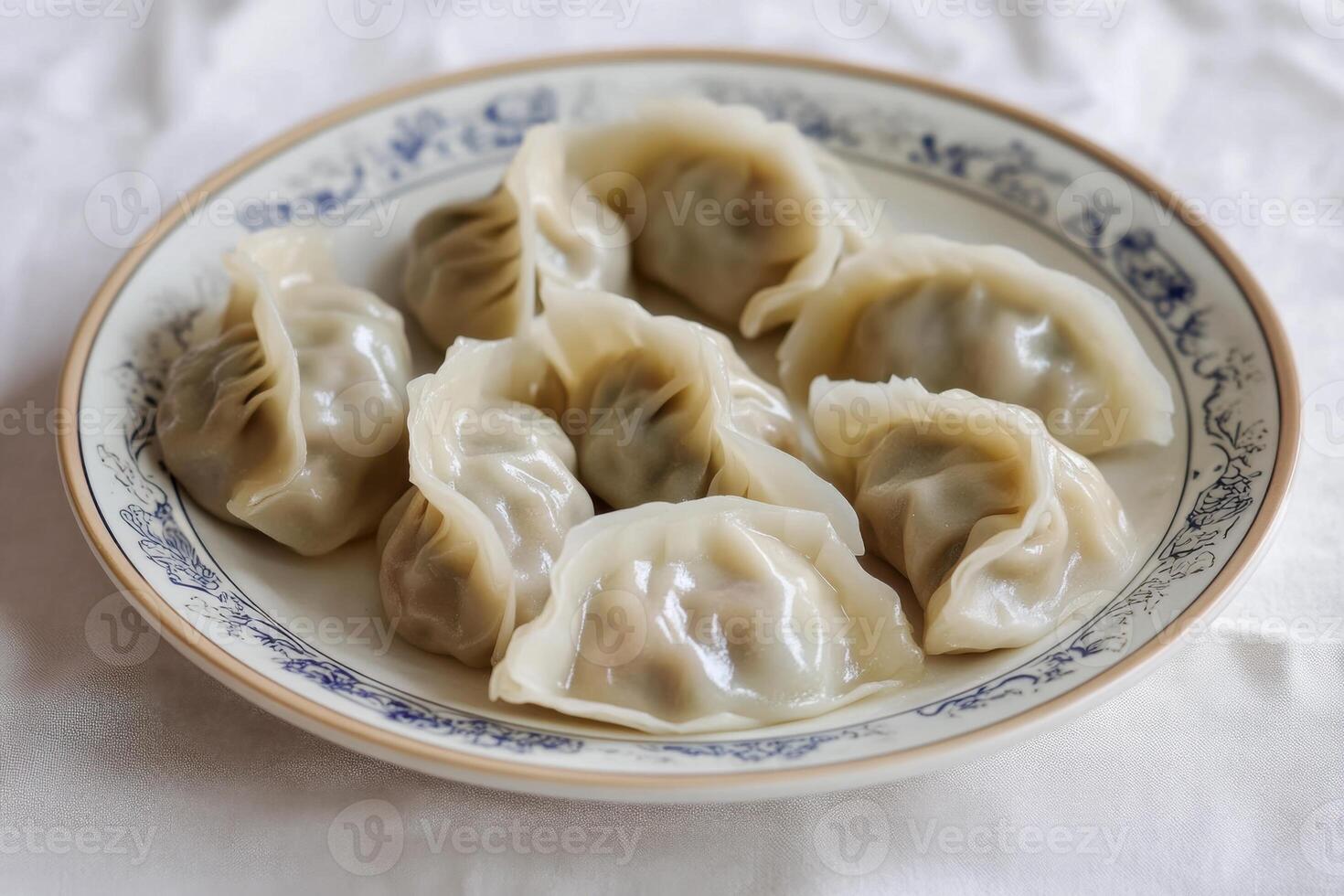Dumplings with a delicate mushroom filling, served on a handcrafted ceramic plate. A clean, light background. photo