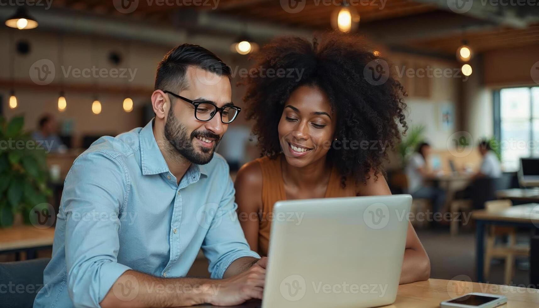 A man and woman are looking at a laptop together photo