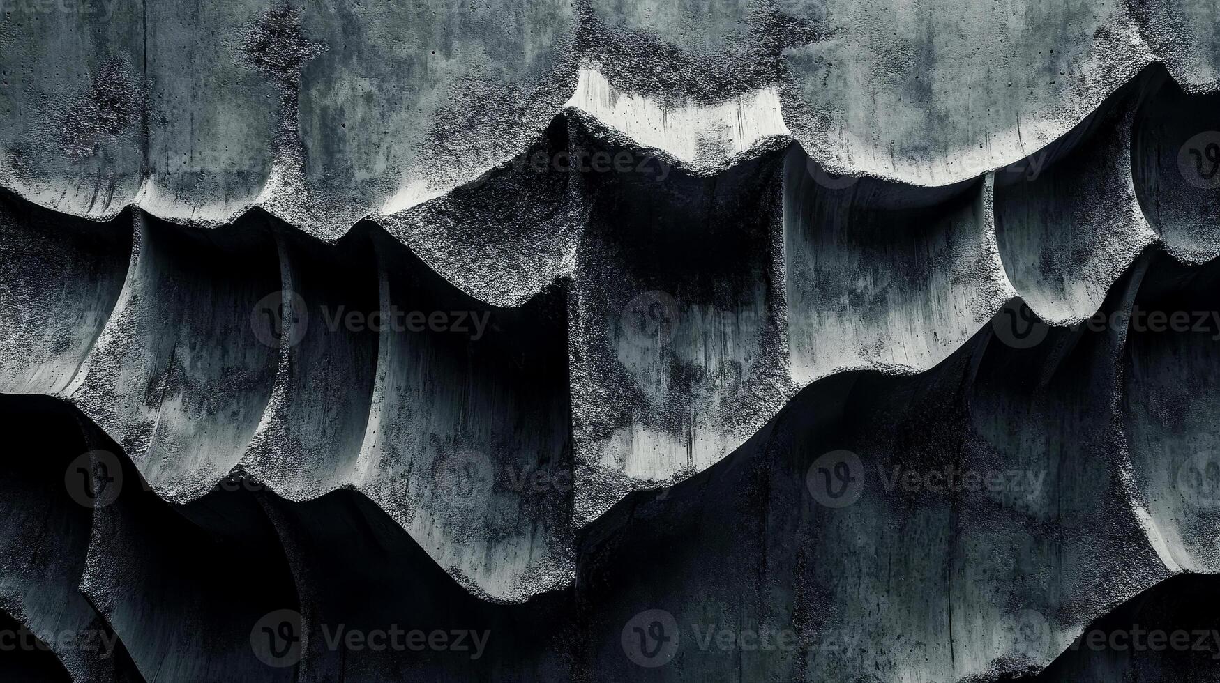 Rough, dark concrete displays an abstract arrangement of layered textures creating depth and interest. The patterns present a modern and industrial aesthetic photo