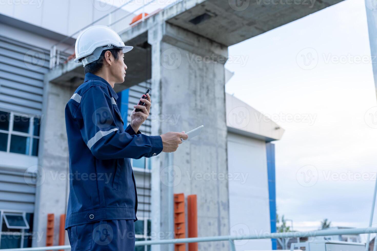 maintenance and inspector. Maintenance engineers are using walky talky to inform the results of inspection of buildings and structures. Irrigation engineers are exploring sluice photo