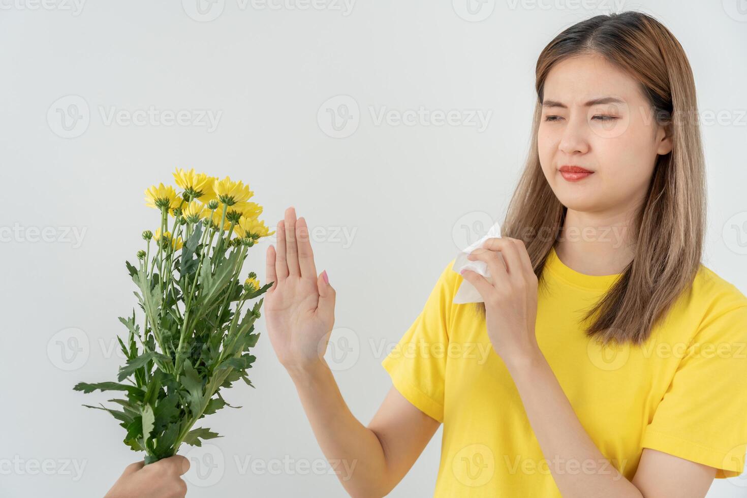 Pollen Allergies, asian young woman sneezing in a handkerchief or blowing in a wipe, allergic to wild spring flowers or blossoms during spring. allergic reaction photo