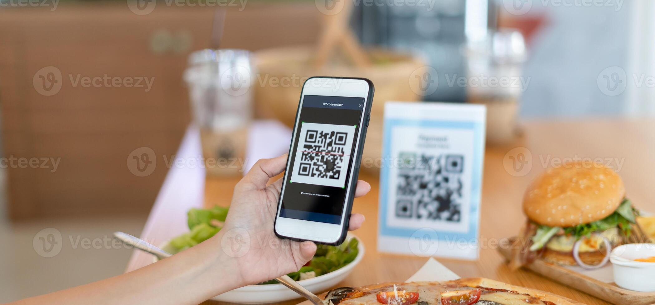 Woman use smartphone to scan QR code to pay in cafe restaurant with a digital payment without cash. Choose menu and order accumulate discount. E wallet, technology photo