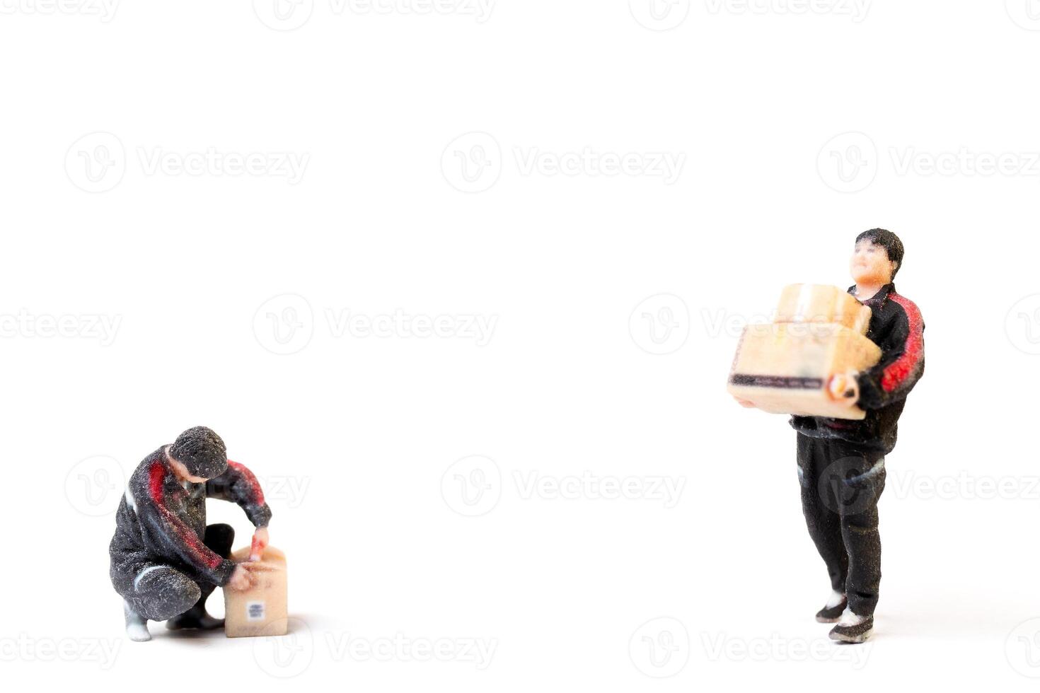 Miniature figurine of a twodelivery worker carrying packages Concept of service and reliability in a creative photo