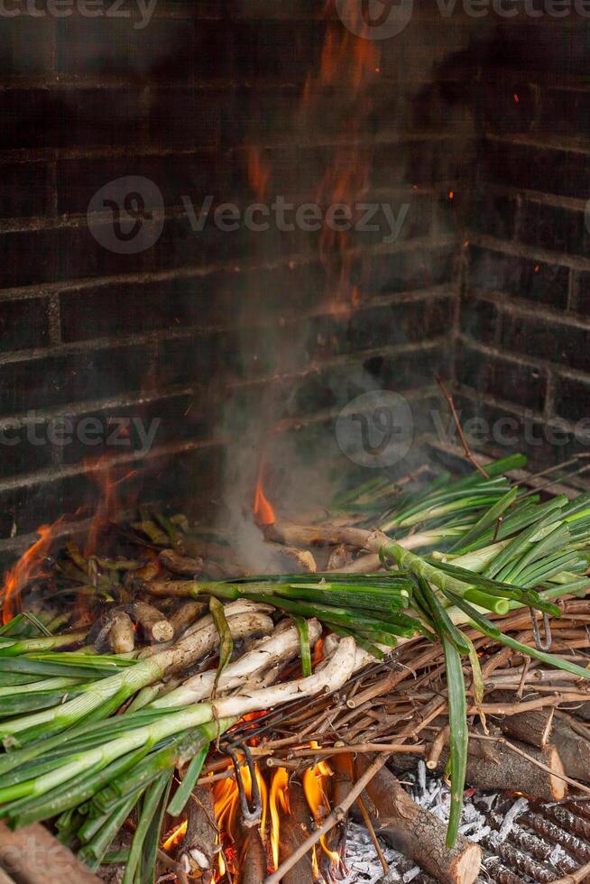 Authentic Spanish calcots, charred and ready to eat with traditional romesco sauce. photo