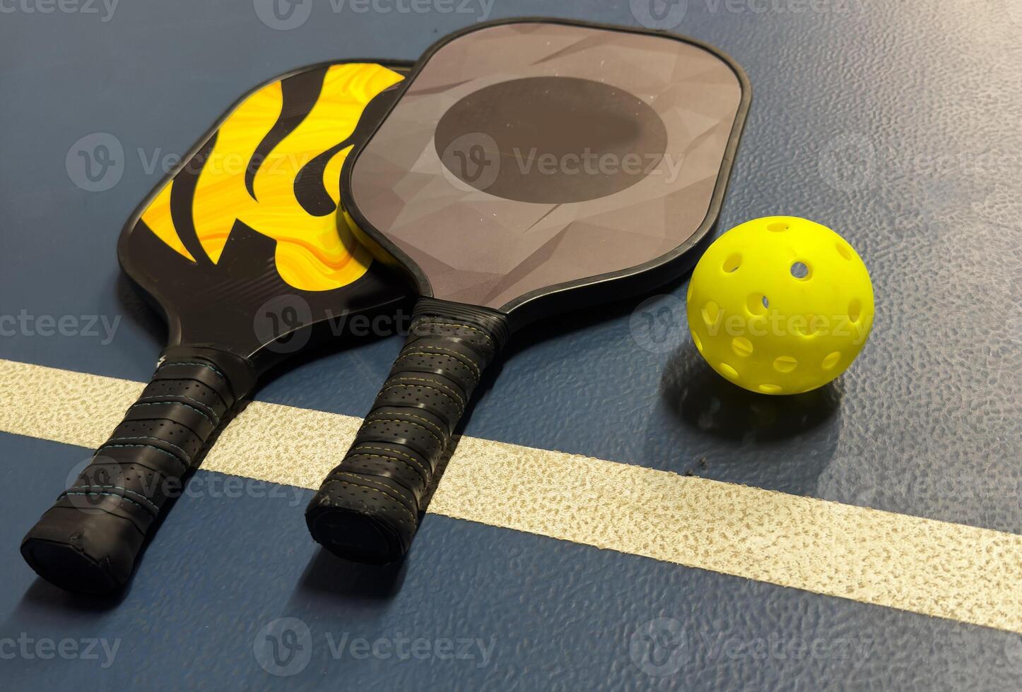 Pickleball tennis racket on the court. Blue background with copy space. Sport court and ball. photo