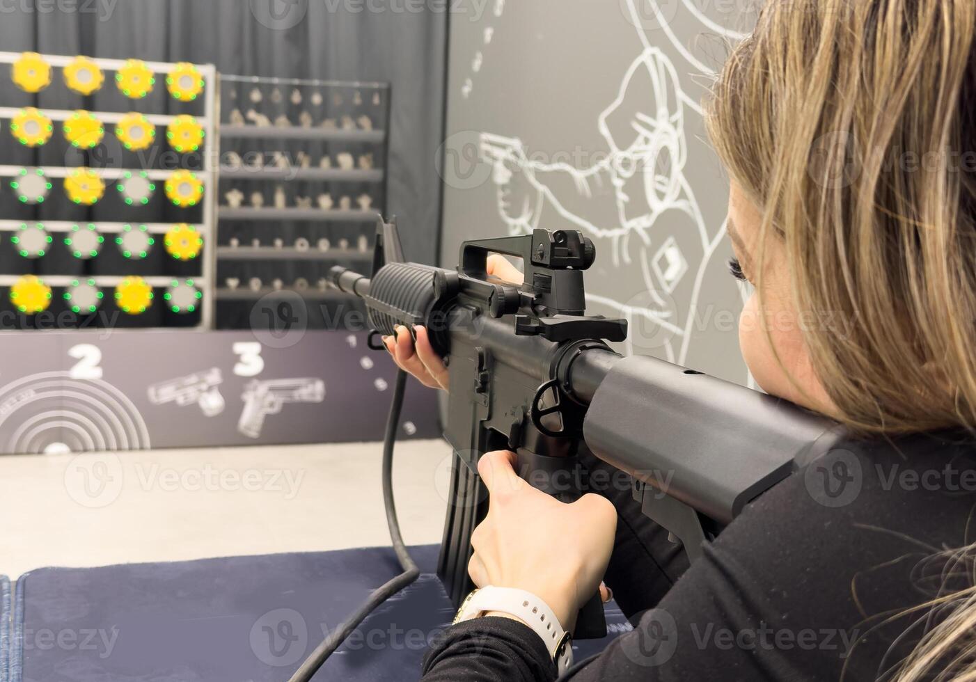 Shooters practicing tactical shooting in a modern indoor gun range. photo