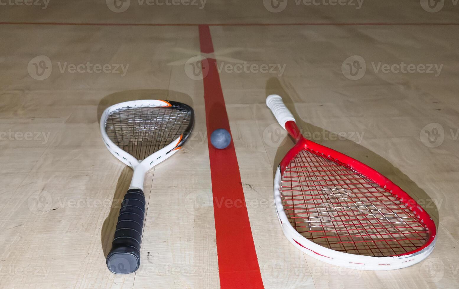 Empty squash court and rackets on the wooden floor. photo