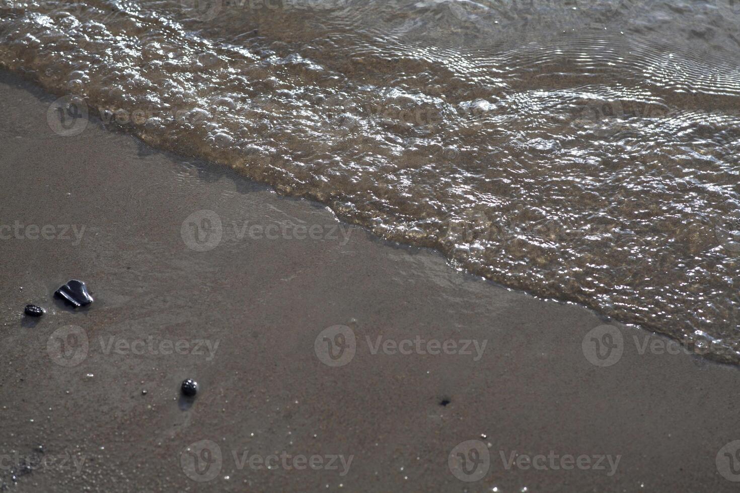 Sea waves to the beach photo