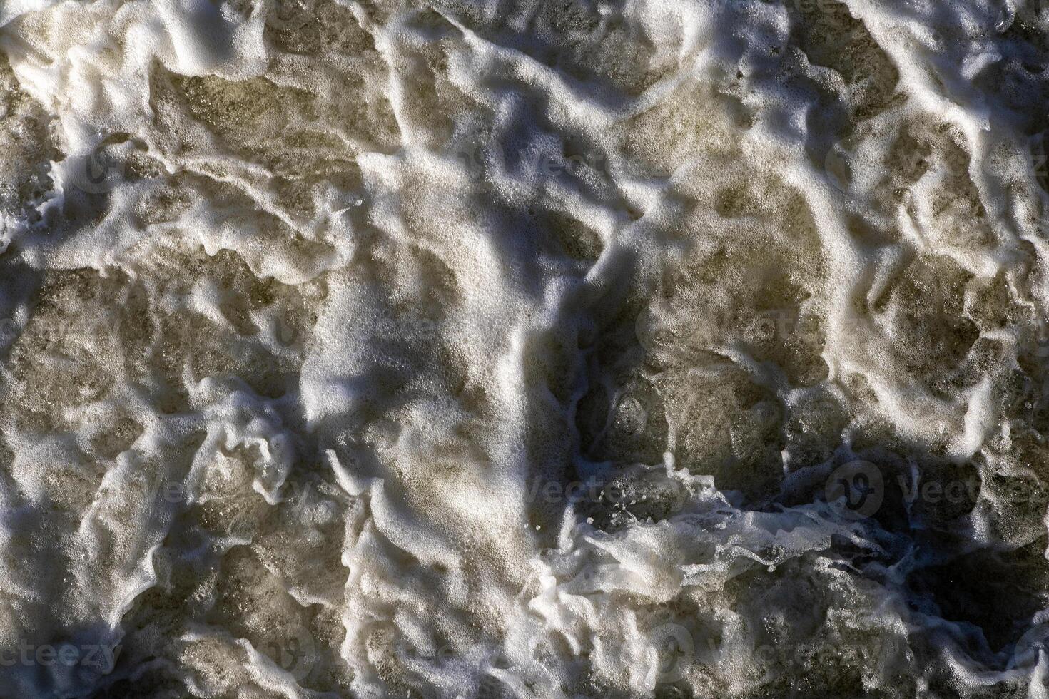 Rough flow of foaming water in the river, close-up, background photo