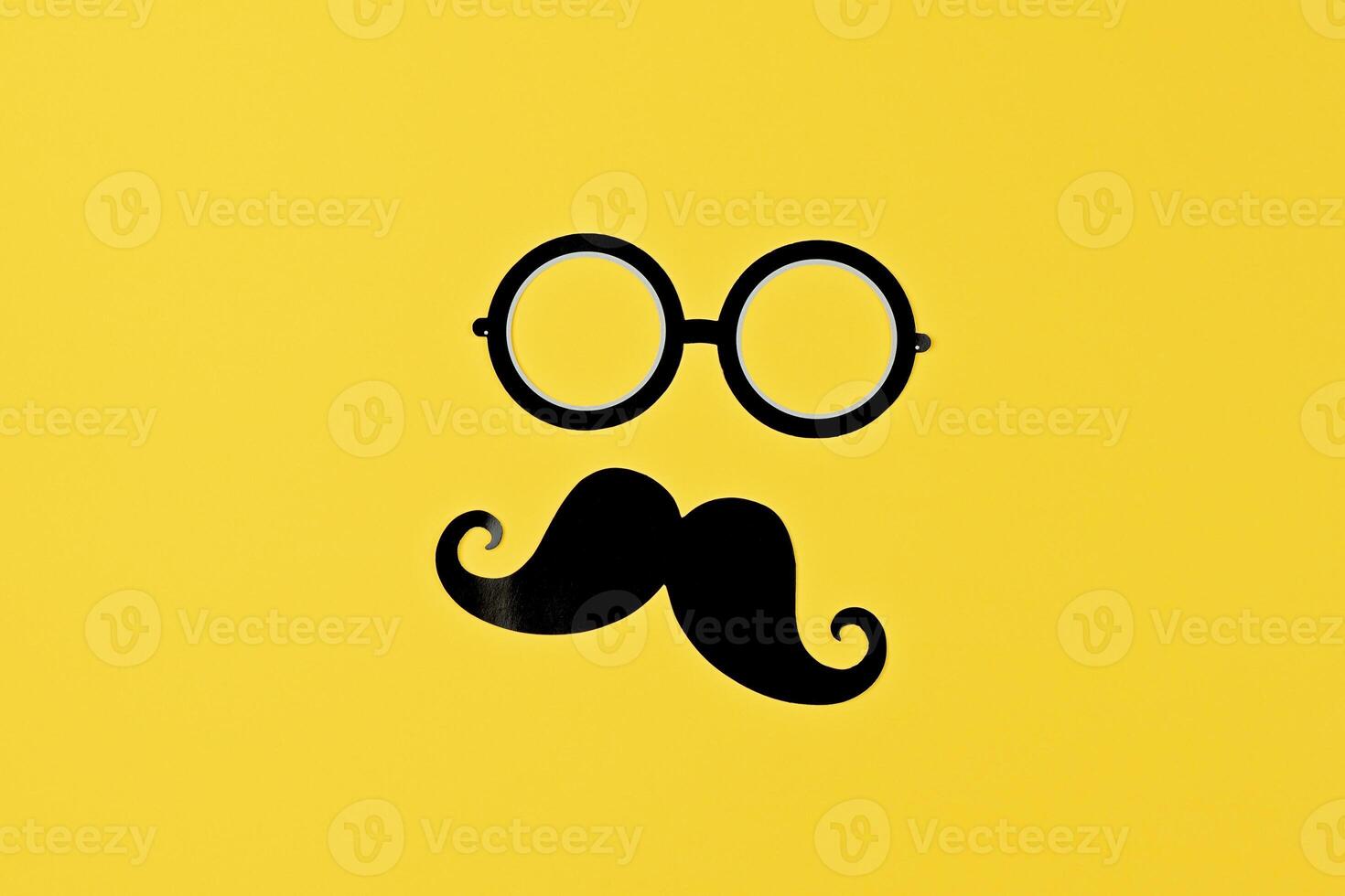 Moustache and glasses silhouette pop on bold yellow surface, showcasing playful style photo