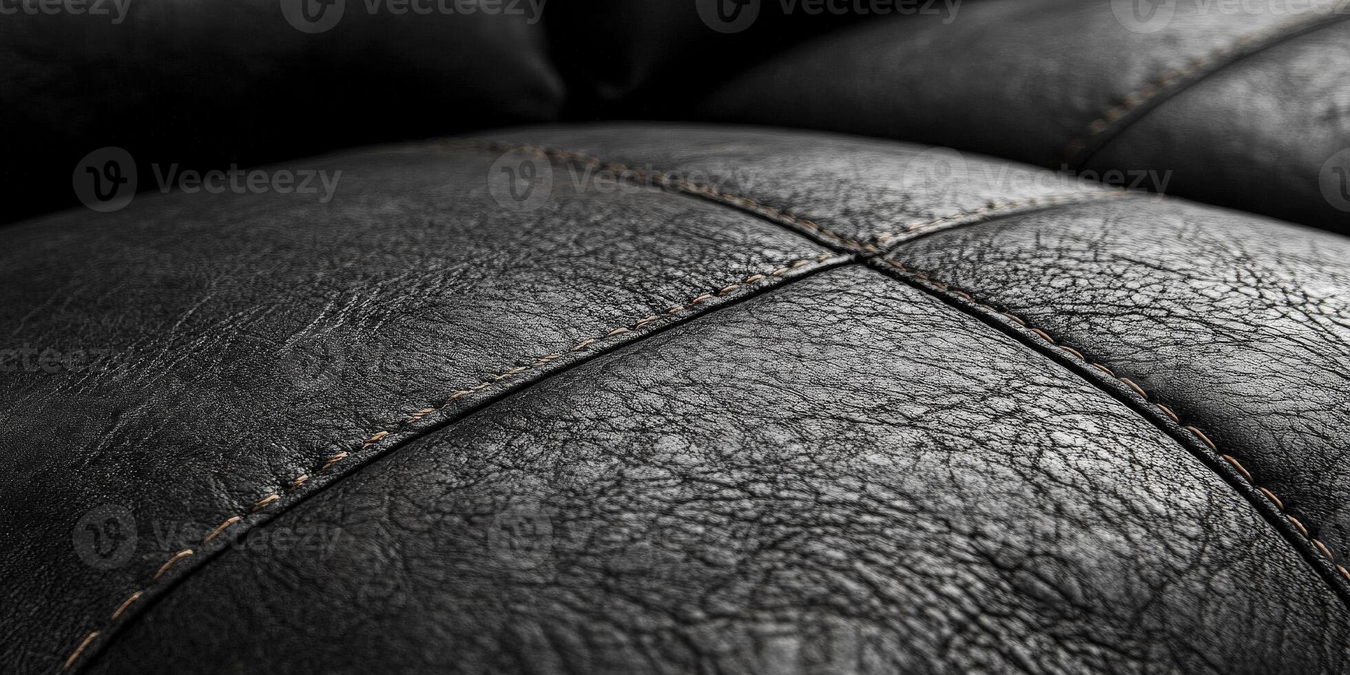 Close-up of textured black leather surface with unique patterns and stitches, representing quality and elegance. photo