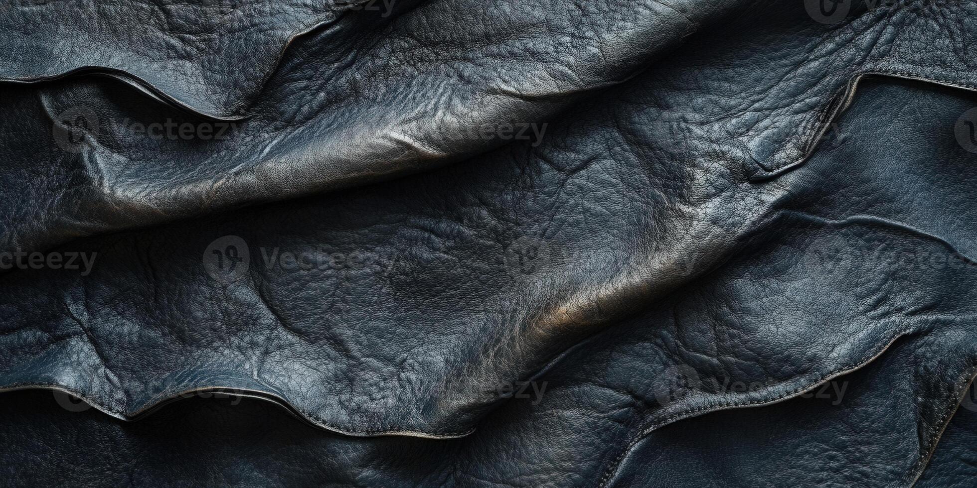 Close-up view of textured black leather, highlighting its waves and folds, perfect for design projects and backgrounds. photo