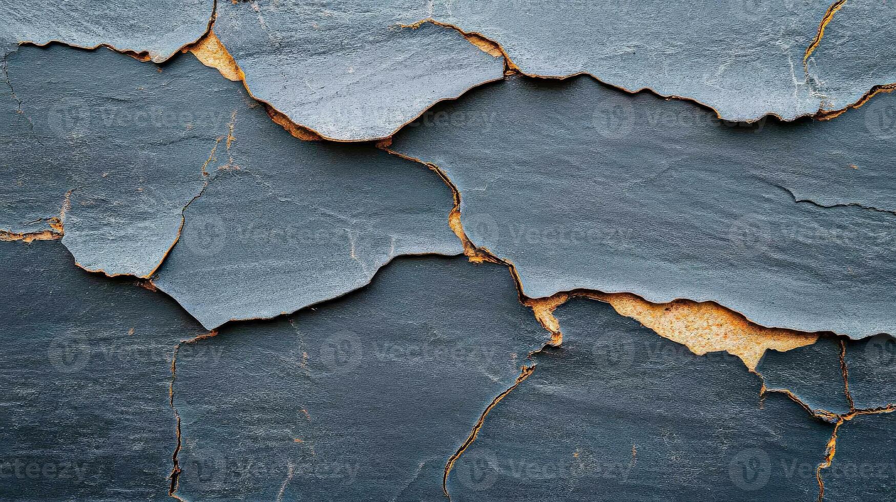 Close-up of textured slate surface showing natural cracks and color variations, perfect for artistic backgrounds. photo