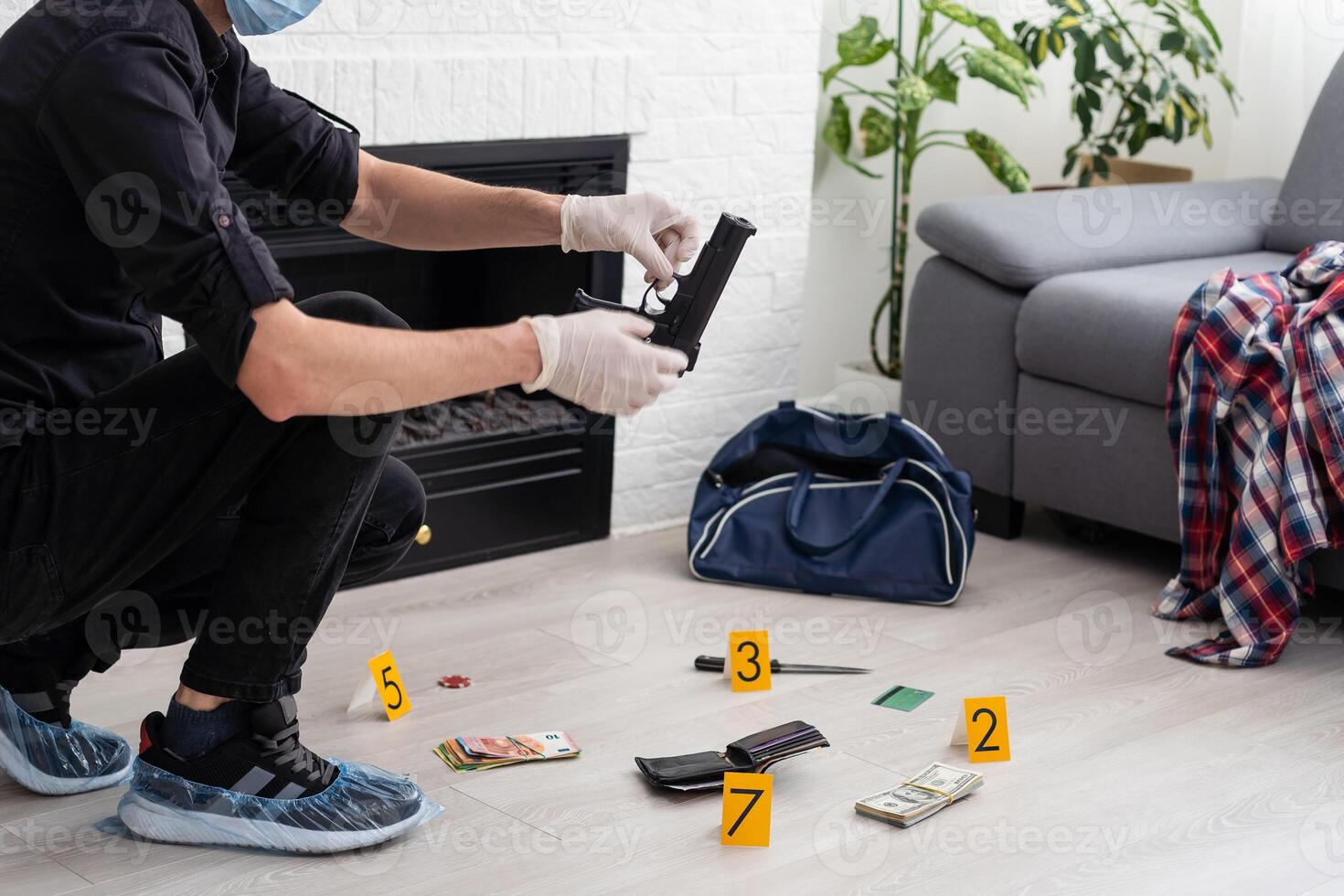 Criminological expert collecting evidence at the crime scene. photo