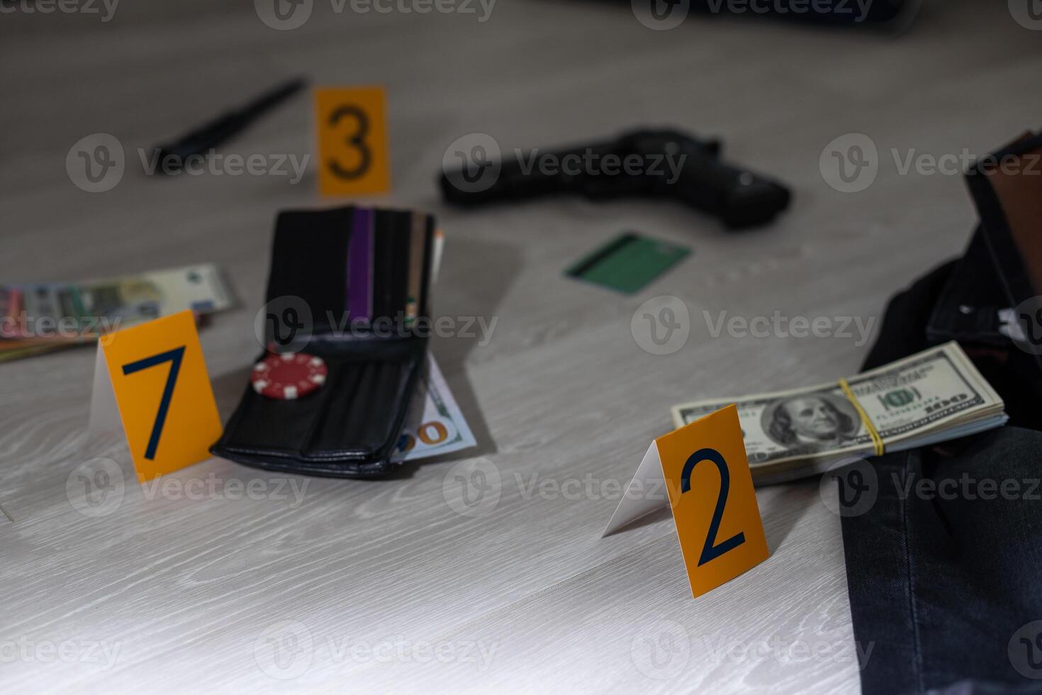 Crime scene investigation - numbering of evidences after the murdering in apartment. Brass knuckle, wallet and clothes with evidence markers photo