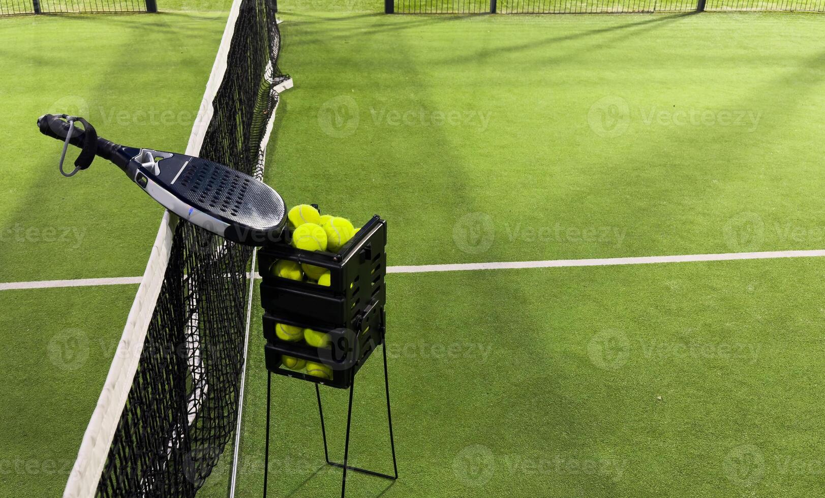Background of padel racket and ball on artificial grass floor in outdoor court. Top view. photo