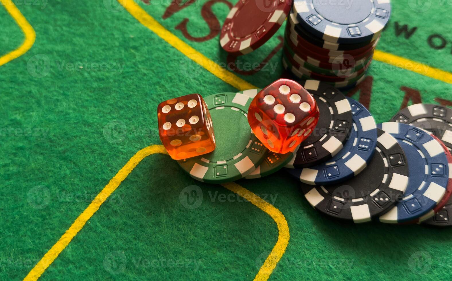 Rolling red dice on a casino table with chips photo