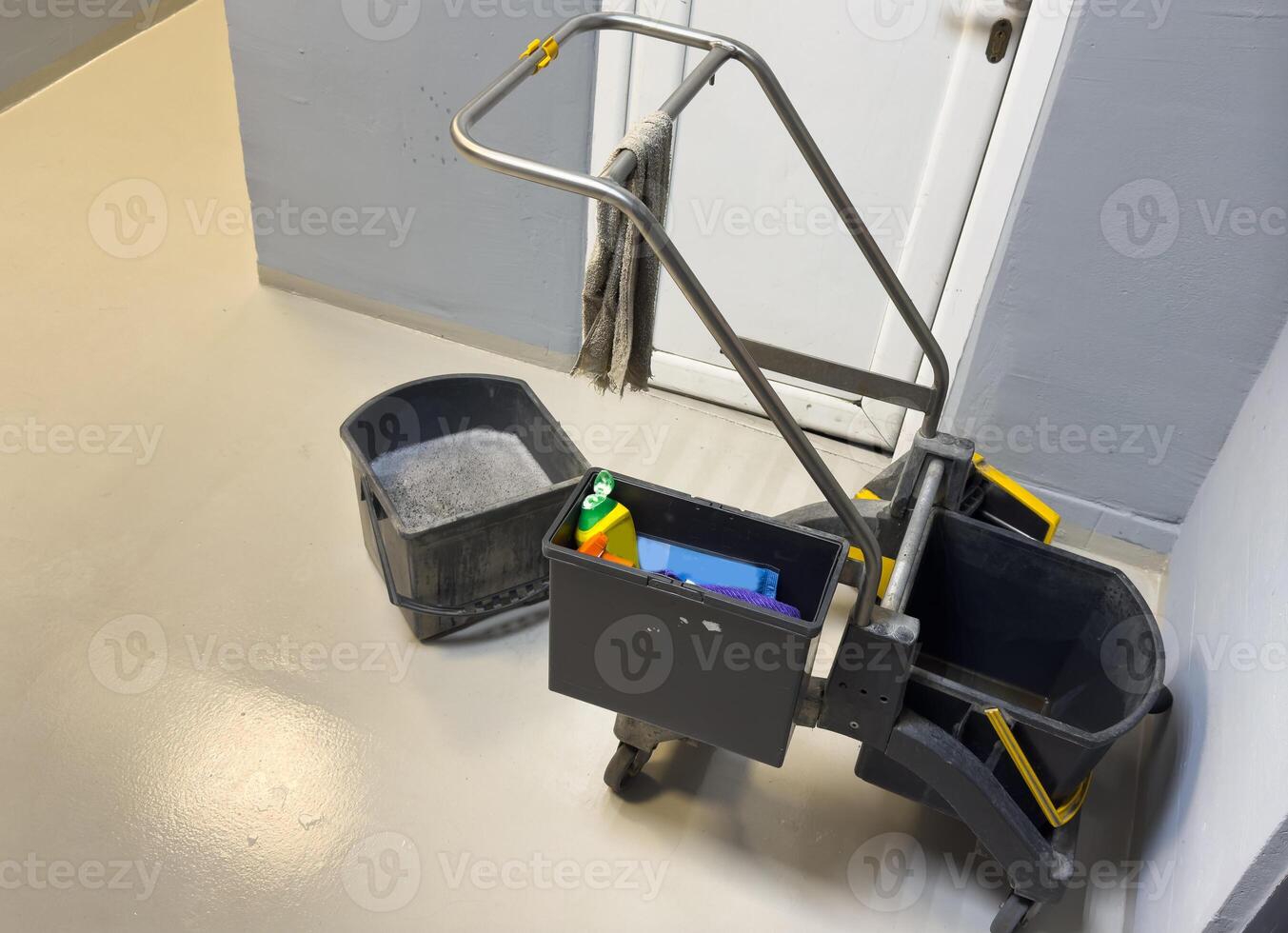 Cleaning tools cart wait for cleaning. Bucket and set of cleaning equipment in the office and Department store. cleaning service concept photo