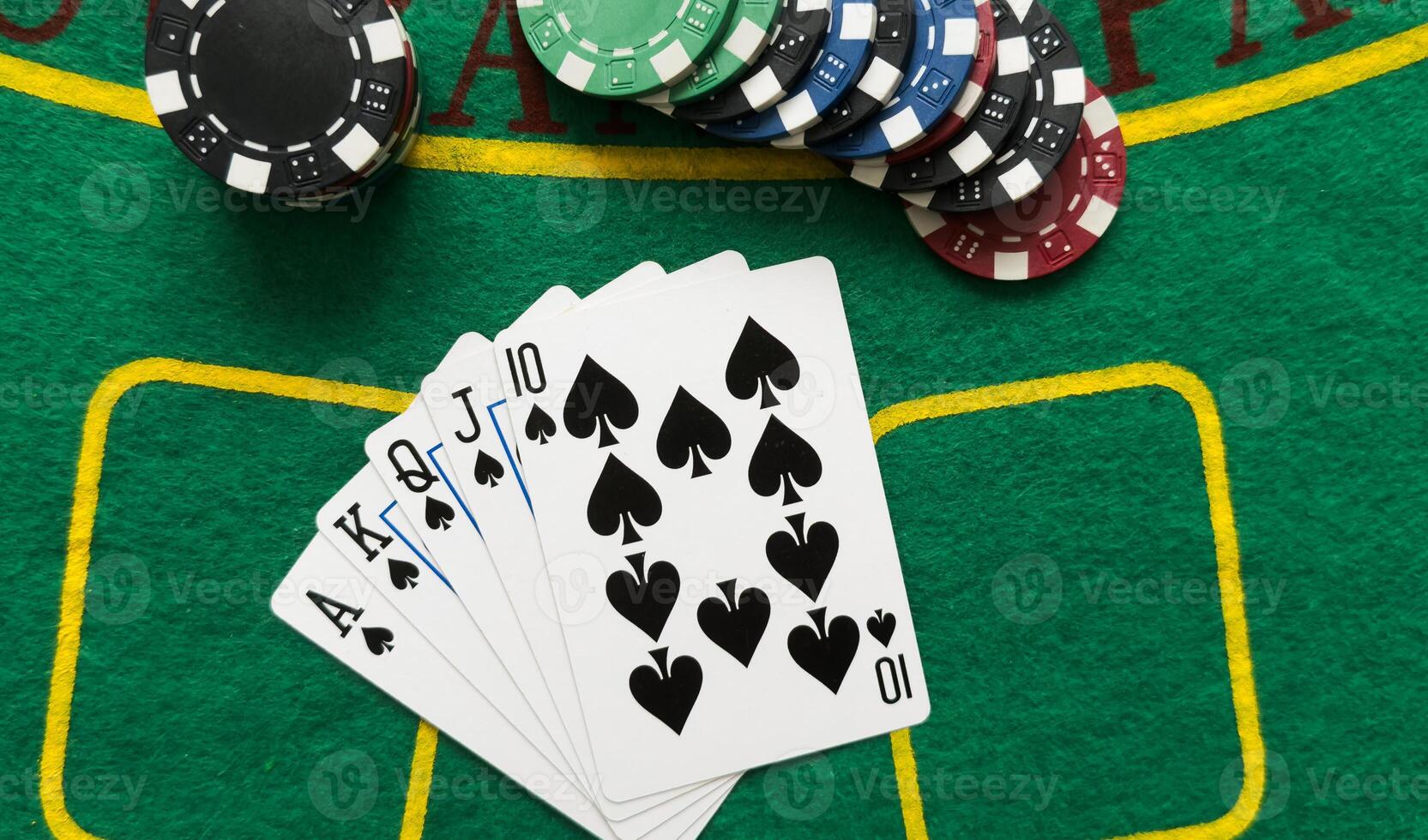 A popular and exciting poker game with a winning combination. Playing cards and chips on a table in a poker club. Advertising space. photo