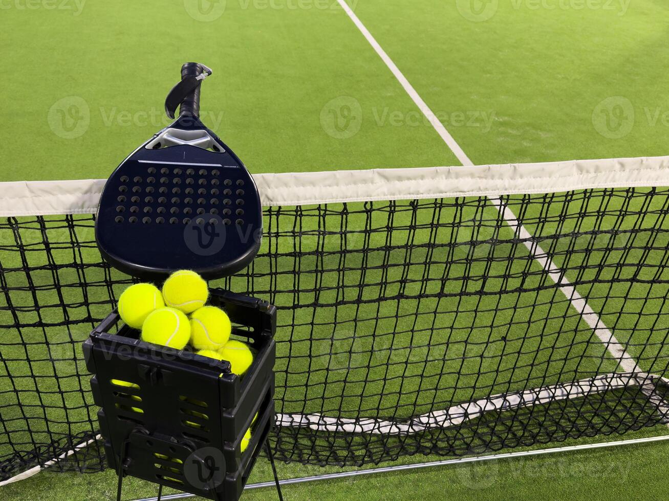 Background of padel racket and ball on artificial grass floor in outdoor court. Top view. photo