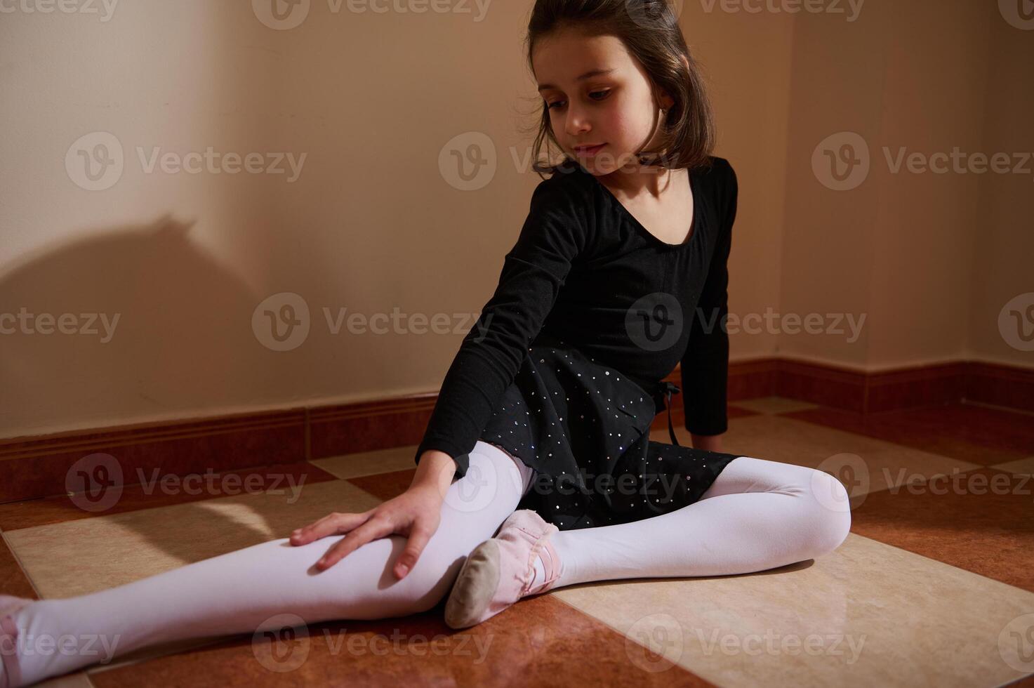 Young girl practicing ballet poses in a calm and focused atmosphere indoors photo