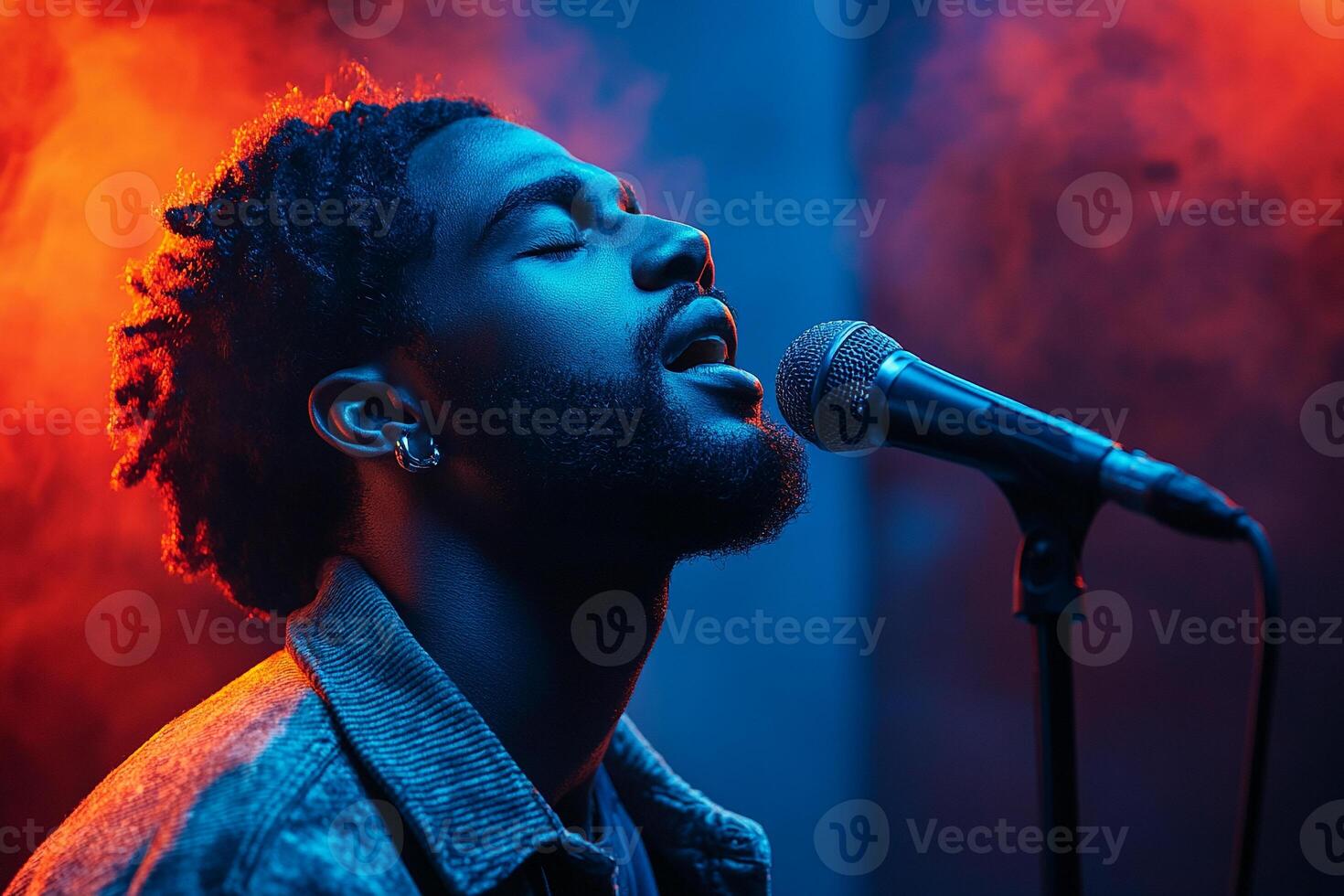 Passionate Performance. Close-up of a passionate singer with dramatic red and blue lighting photo