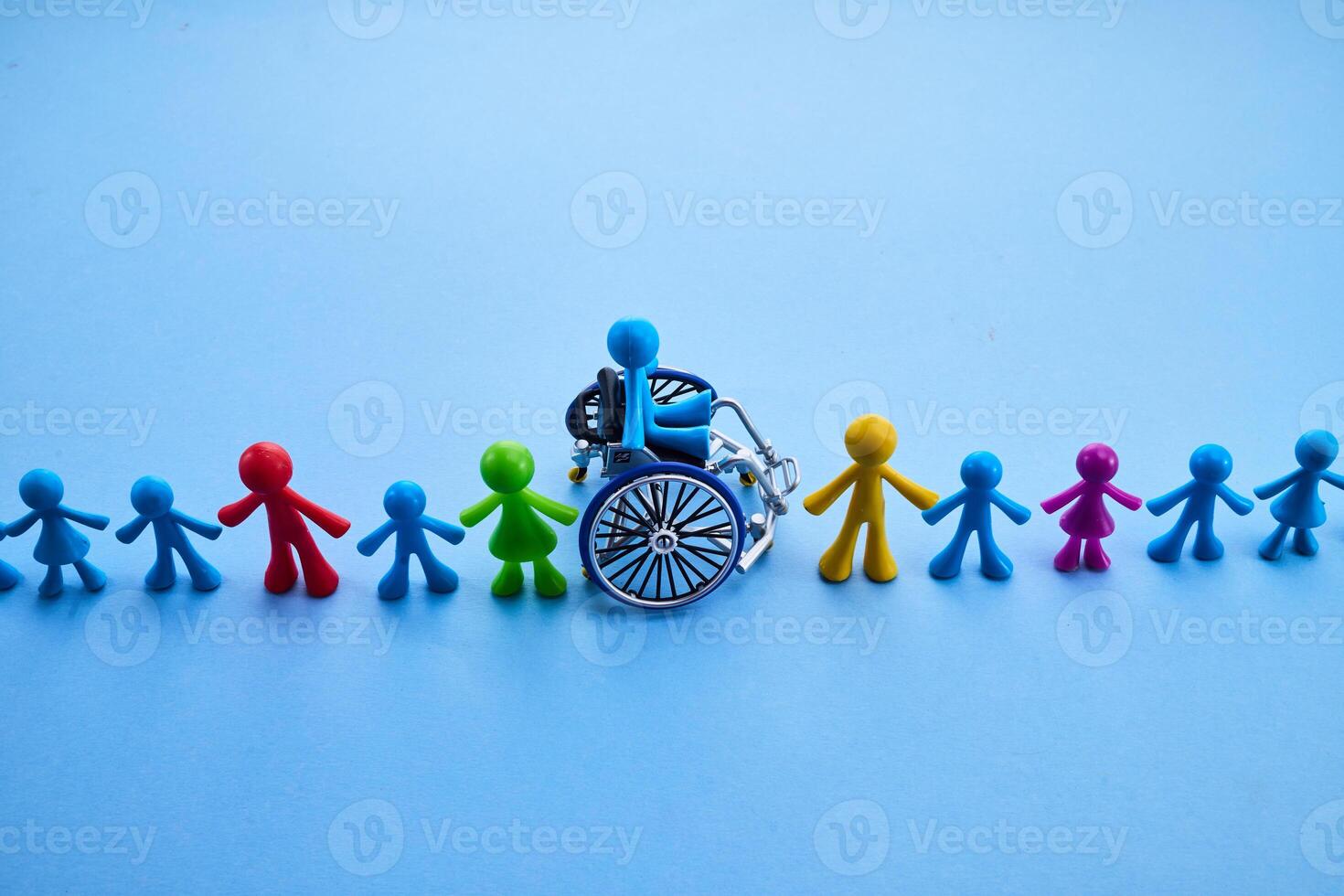 Inclusivity. Colorful figures holding hands with one in a wheelchair, symbolizing inclusion. photo